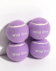 Purple tennis balls that read, "Wild One" in white text.