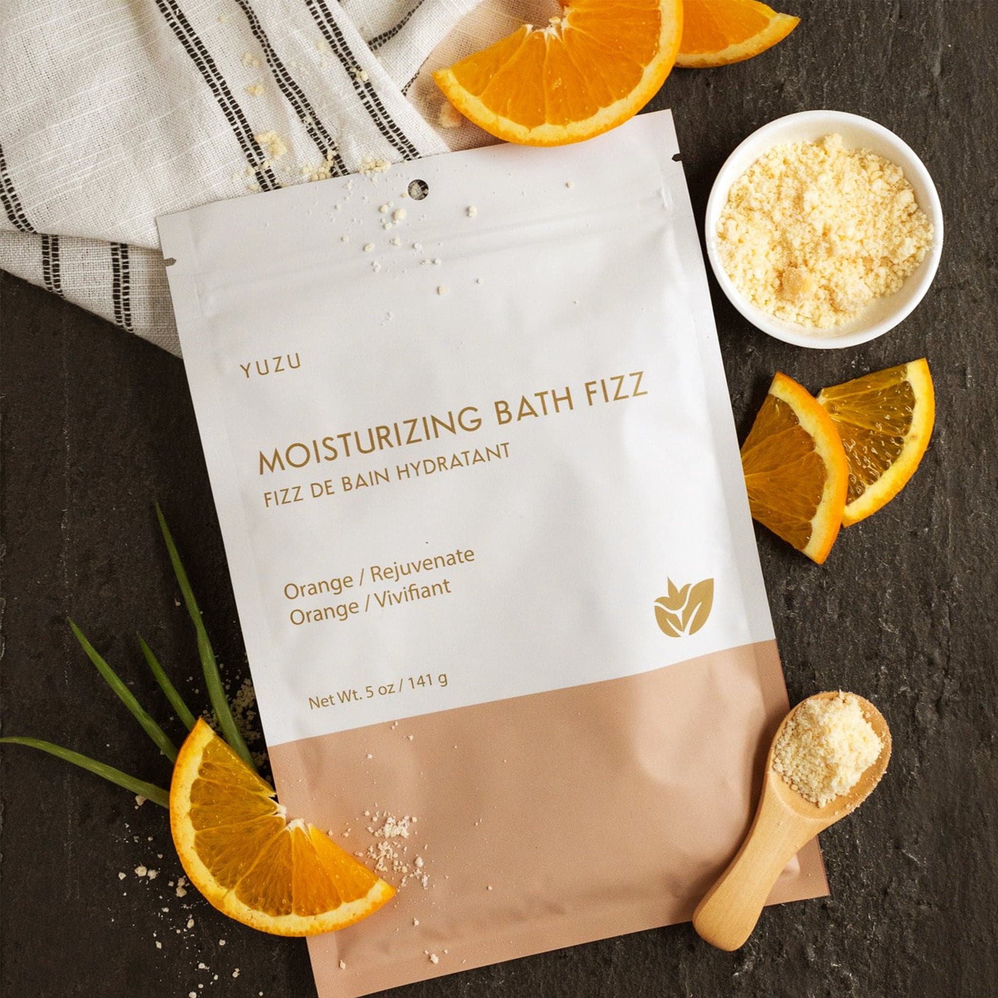 This bath fizz is packaged in a resealable white and pink envelope with gold writing that reads, &quot;Moisturizing Bath Fizz, Orange / Rejuvinate&quot;