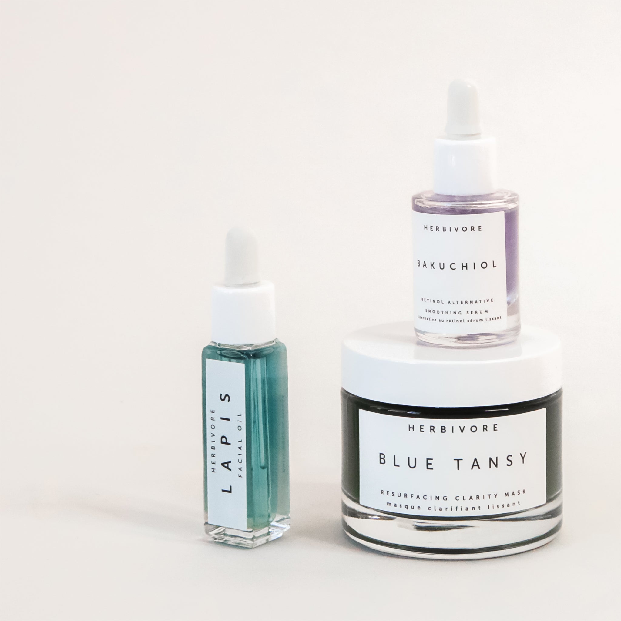 product shot of herbivore's lapis facial oil, bakuchiol serum, and blue tansy mask all on a white ground