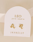 gold earrings in the shape of the leo zodiac sign