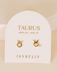 gold earrings in the shape of the taurus zodiac sign