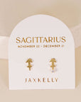 gold earrings in the shape of the sagittarius zodiac sign