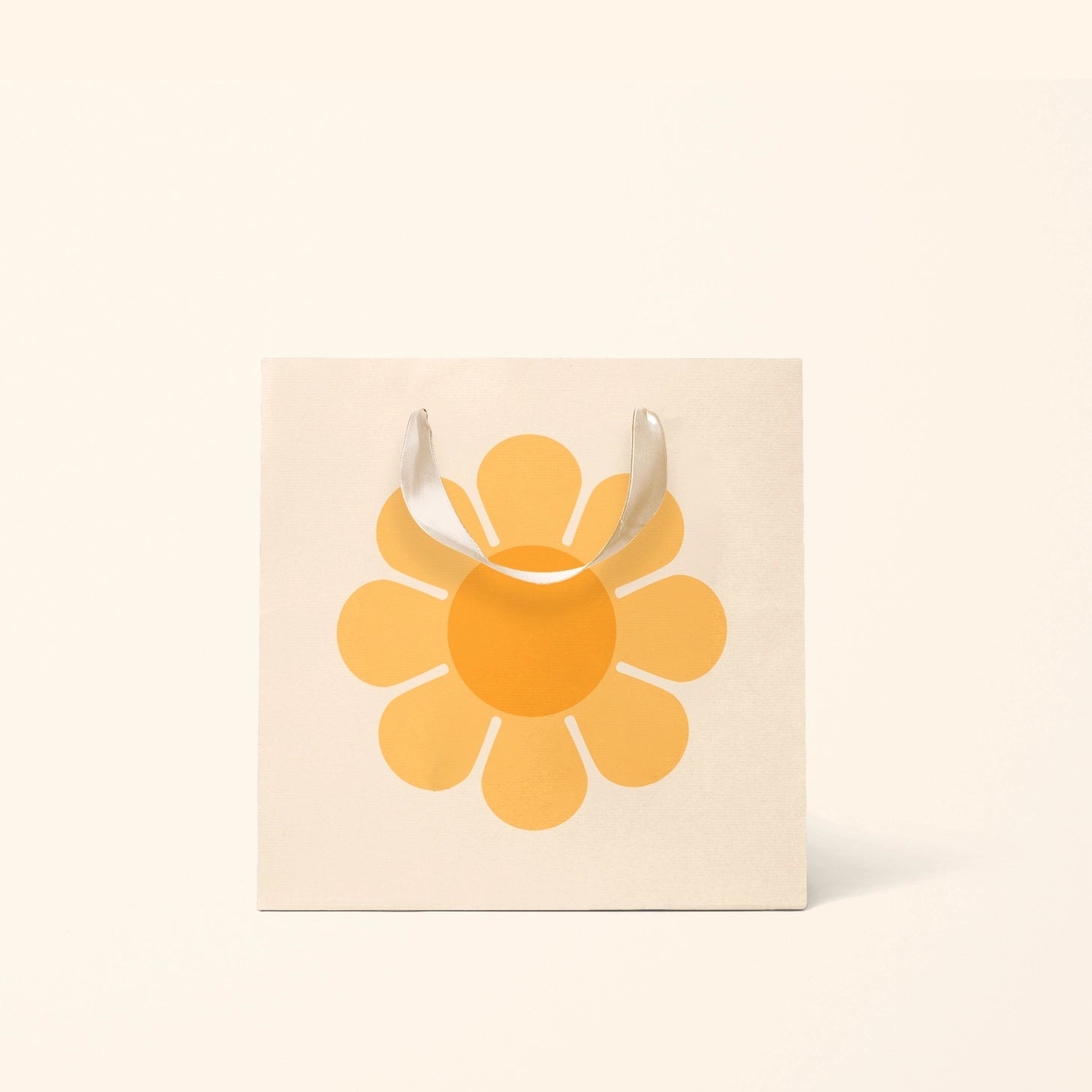 On a cream background is the small ivory gift bag with a yellow flower on it. 
