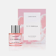 A pink glass bottle of perfume with black text that reads, 'Lake & Skye 1111 Vanilla Eau De Parfum'. 