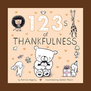 Small cream colored children's book titled "123's of Thankfulness" By Patricia Hegarty, Illustrated by Summer Macon. On the cover are illustrated gold hearts and black and white animals, including a lion, giraffe eating ice cream, mice, rabbits, and a bear hugging a baby penguin.
