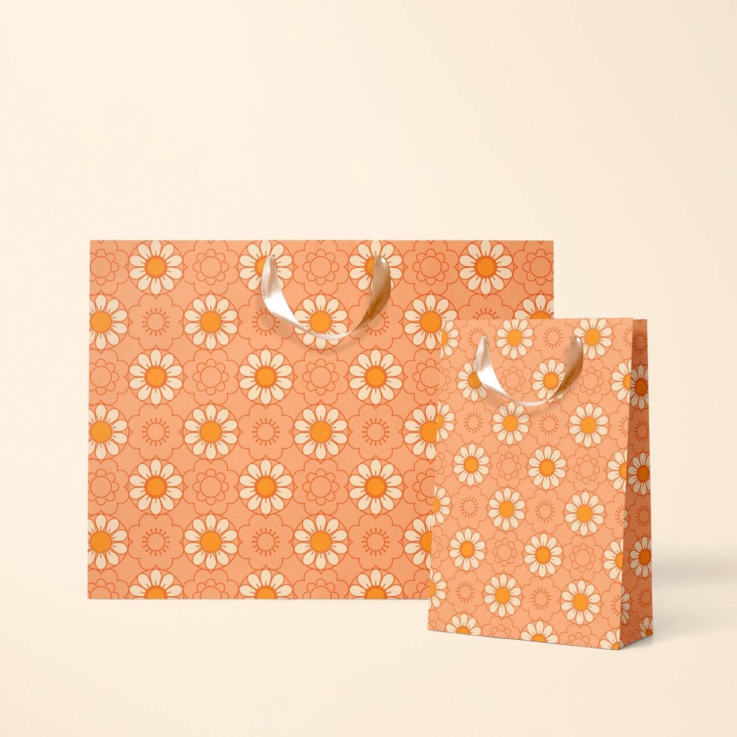 On an ivory background is two orange gift bags with an orange daisy pattern. 