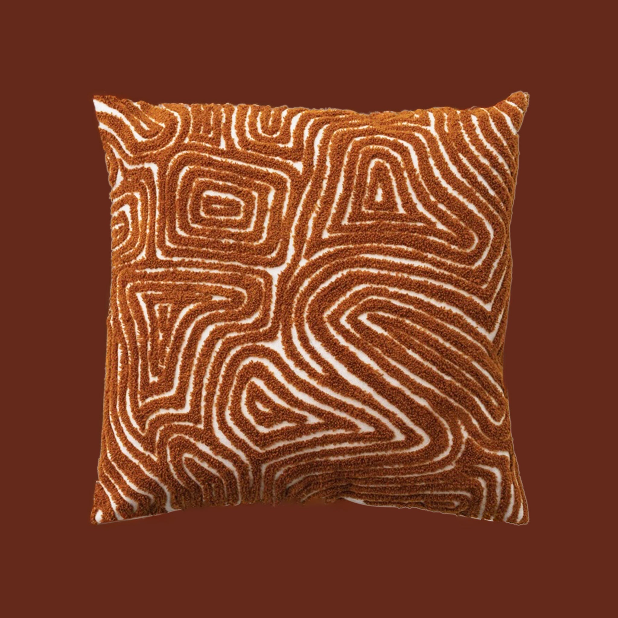 An orange and cream tufted design pillow. 