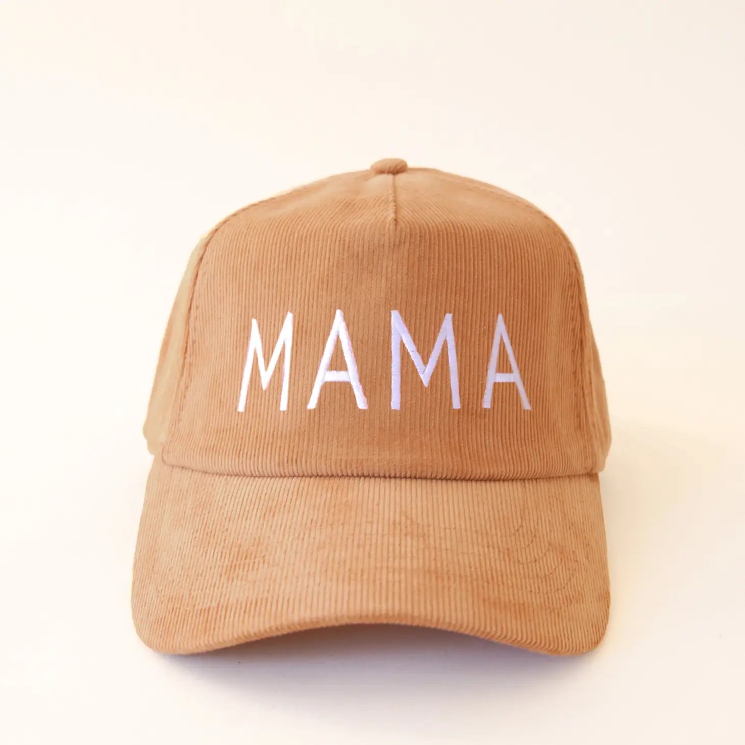 On a white background is a corduroy baseball hat with white embroidered, &quot;MAMA&quot;. 