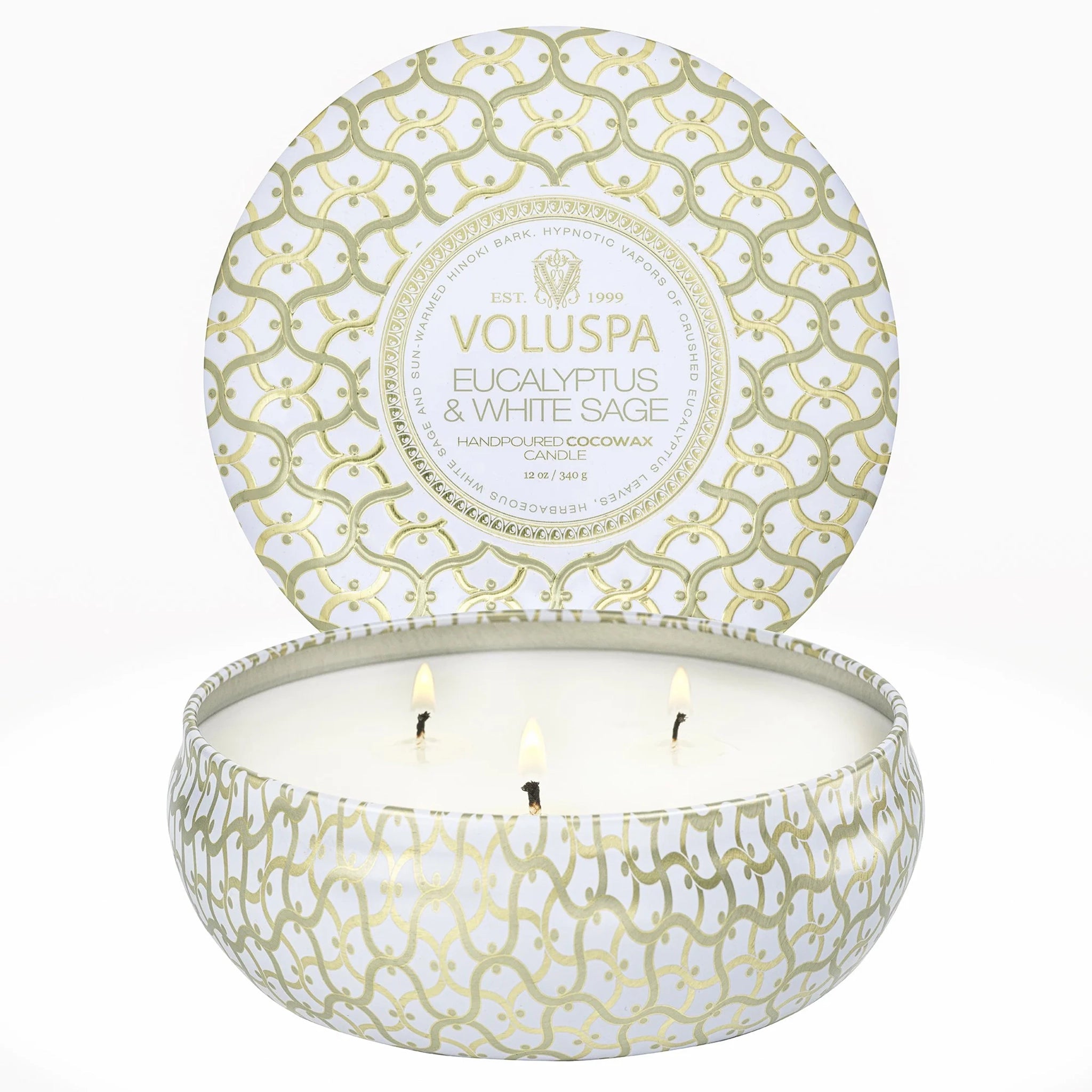 A round three wick candle in a white and gold cross design tin.
