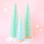 Mint Colored Sisal Christmas trees on a pink background.