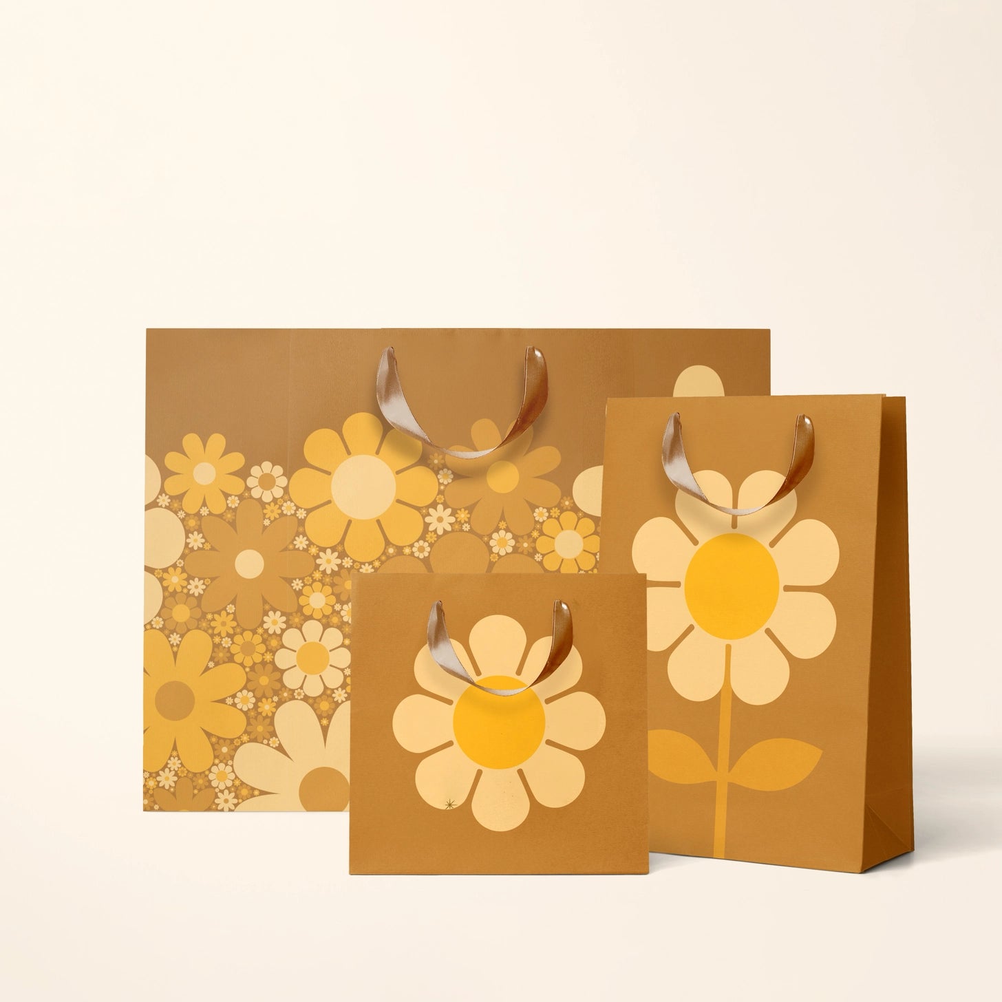 On an ivory background is three brown gift bags with yellow daisies on them. 