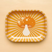 An orange and light pink metal tray with a groovy mushroom graphic in the center.
