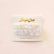 Marbled ivory acetate barrettes on a white ground card that reads, "Jungle Club".