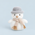 A white snowman shaped stuffed toy with a neutral scarf and a grey fuzzy top 
