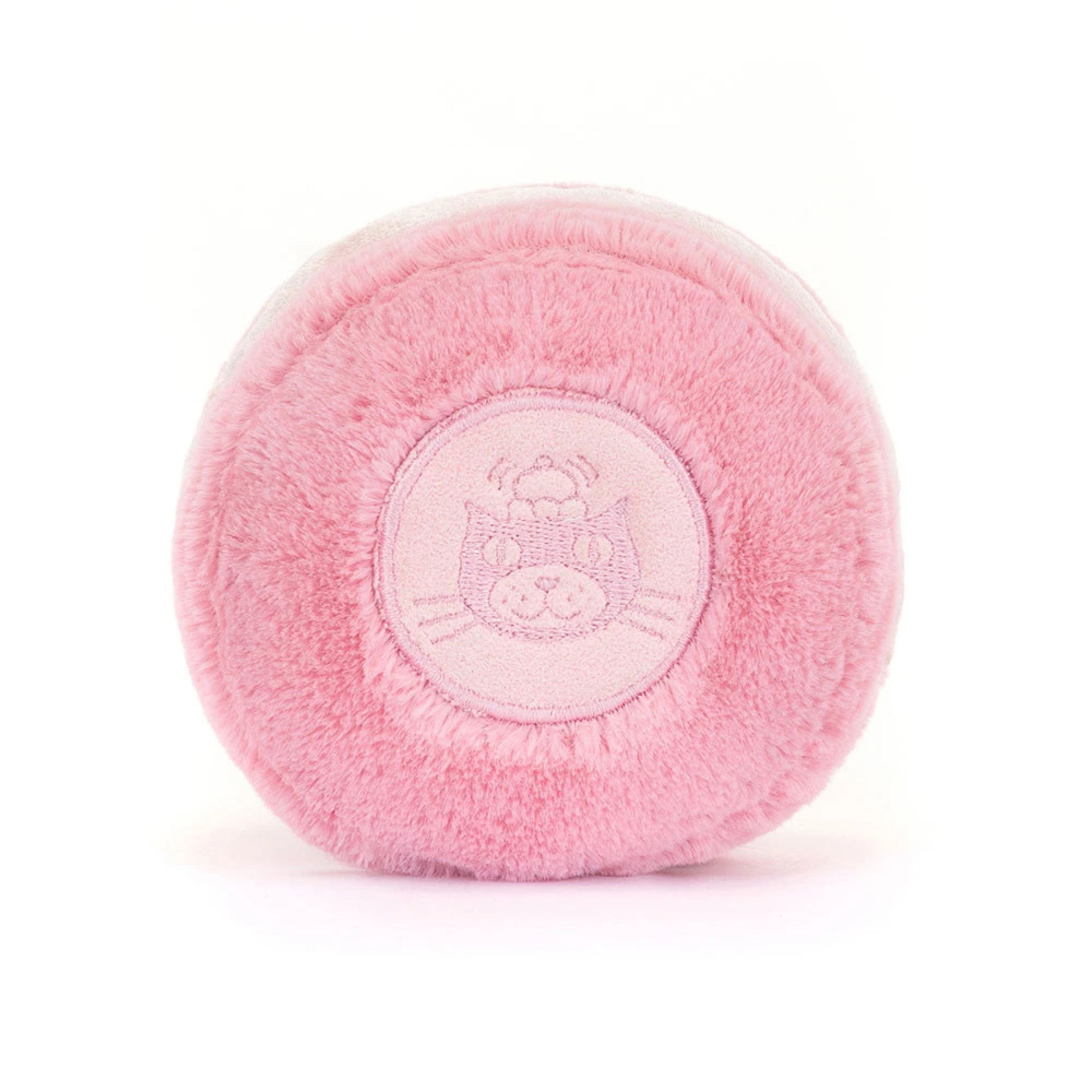 a pink maracon shaped plush toy with corduroy feet and a smiling face. 