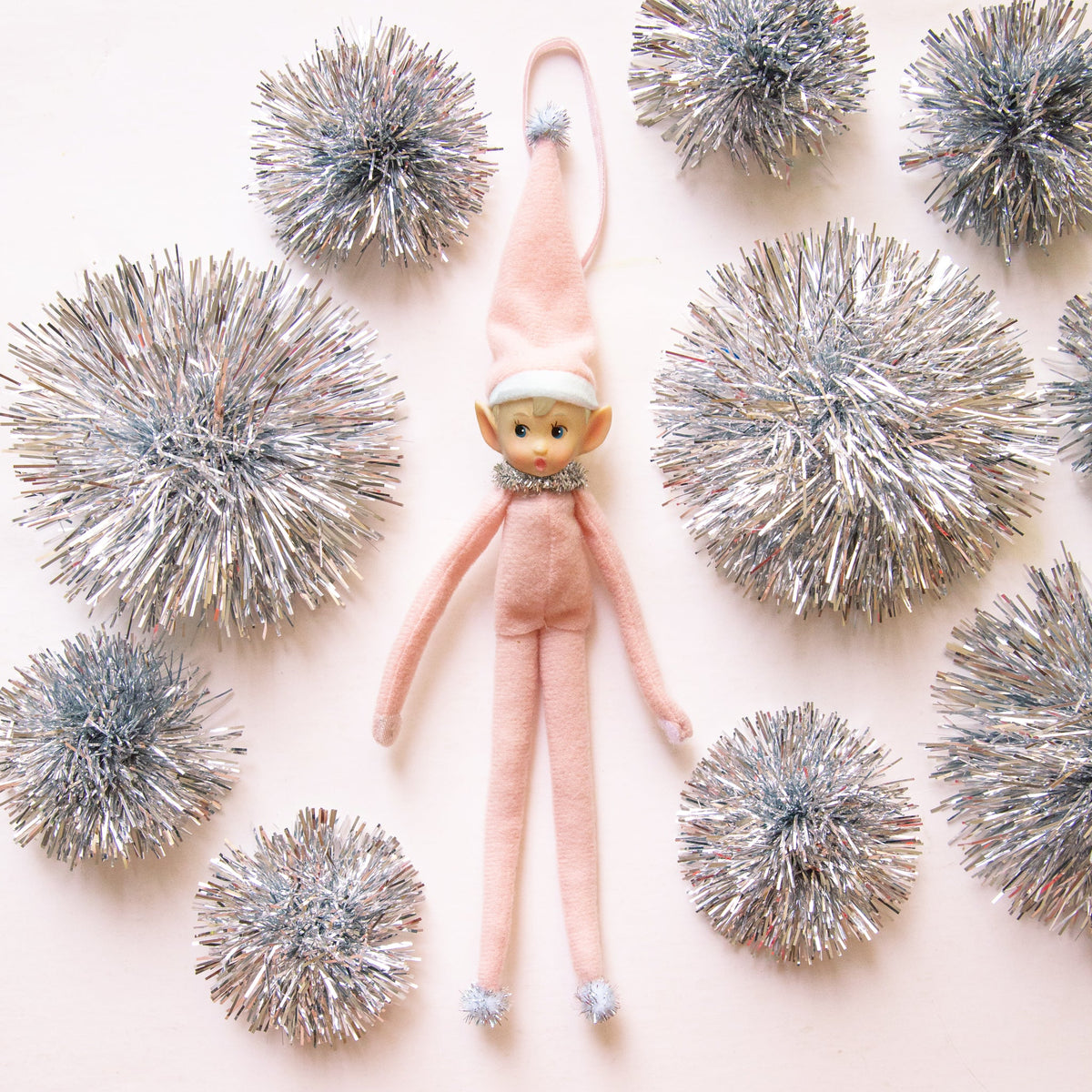 A light pink baby elf ornament. 