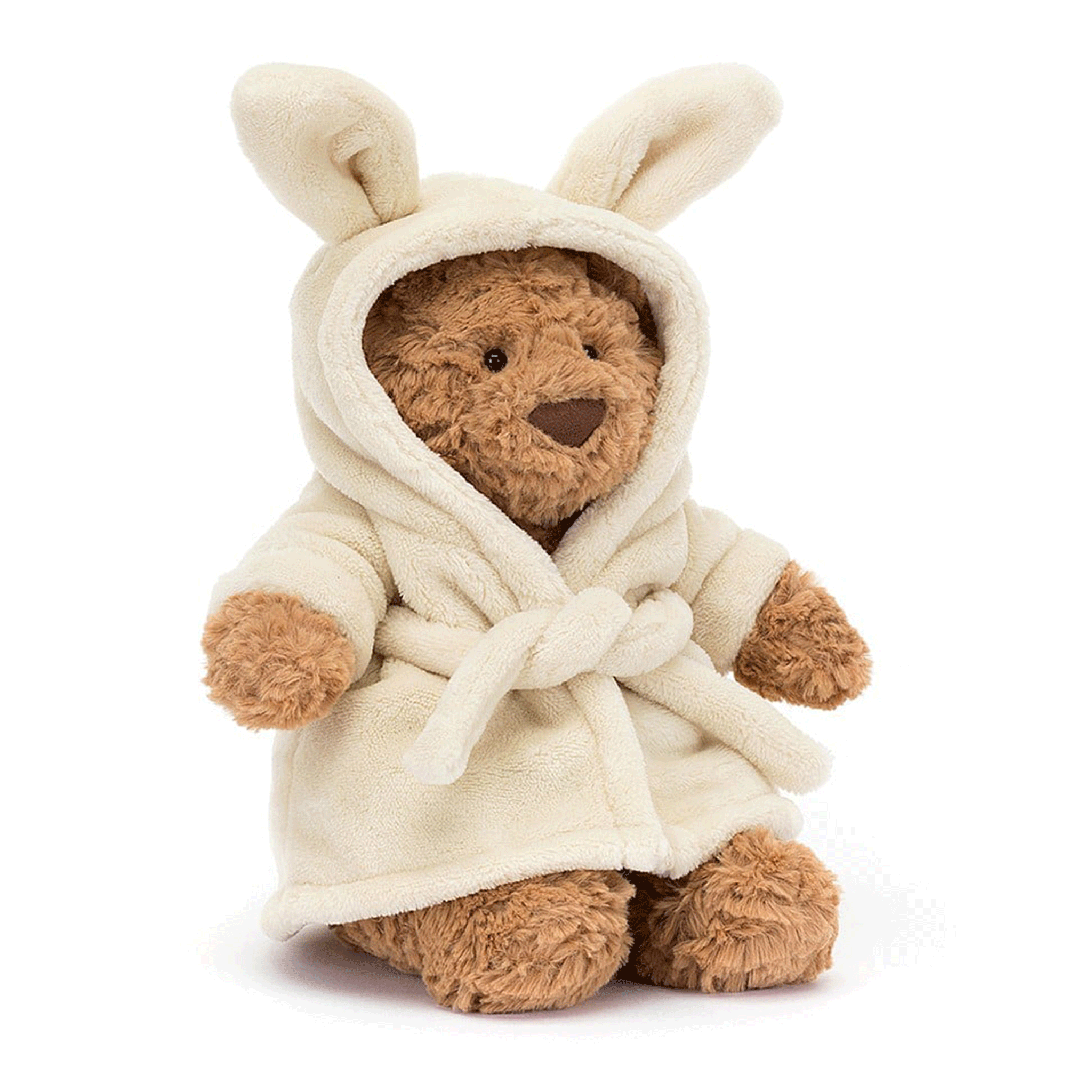 On a white background is a brown stuffed animal bear wearing a fuzzy white rope with bunny ears. 