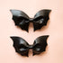 A pair of leather bath shaped hair bows.