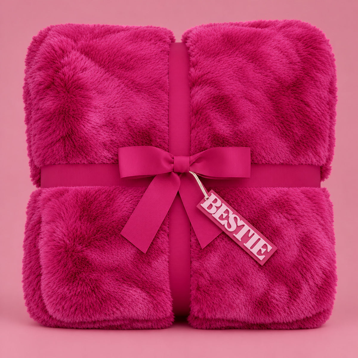 hot pink fur blanket with a tag that reads "bestie".