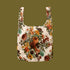Floral patterned reusable bag on a solid background