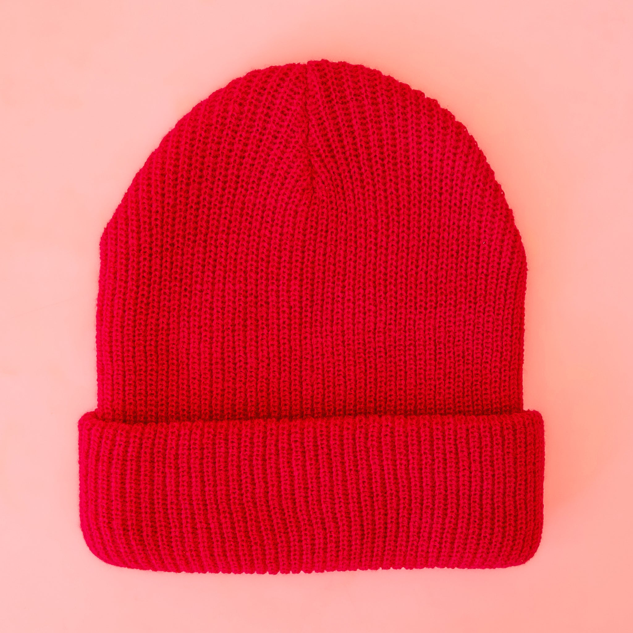 A bright red ribbed beanie. 