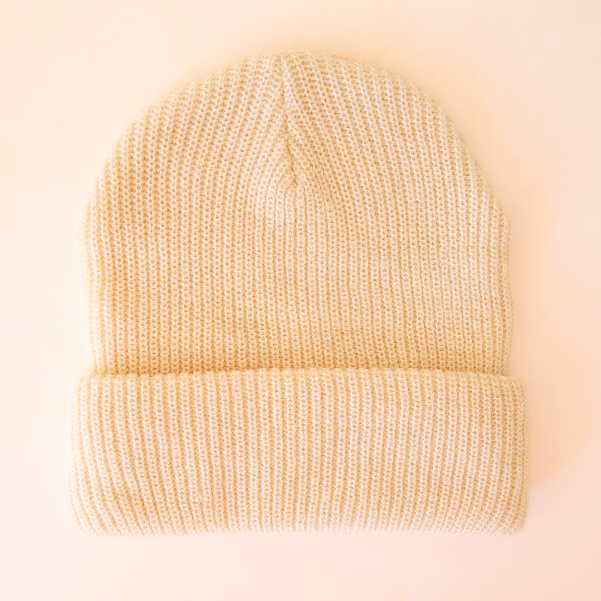A cream colored beanie. 