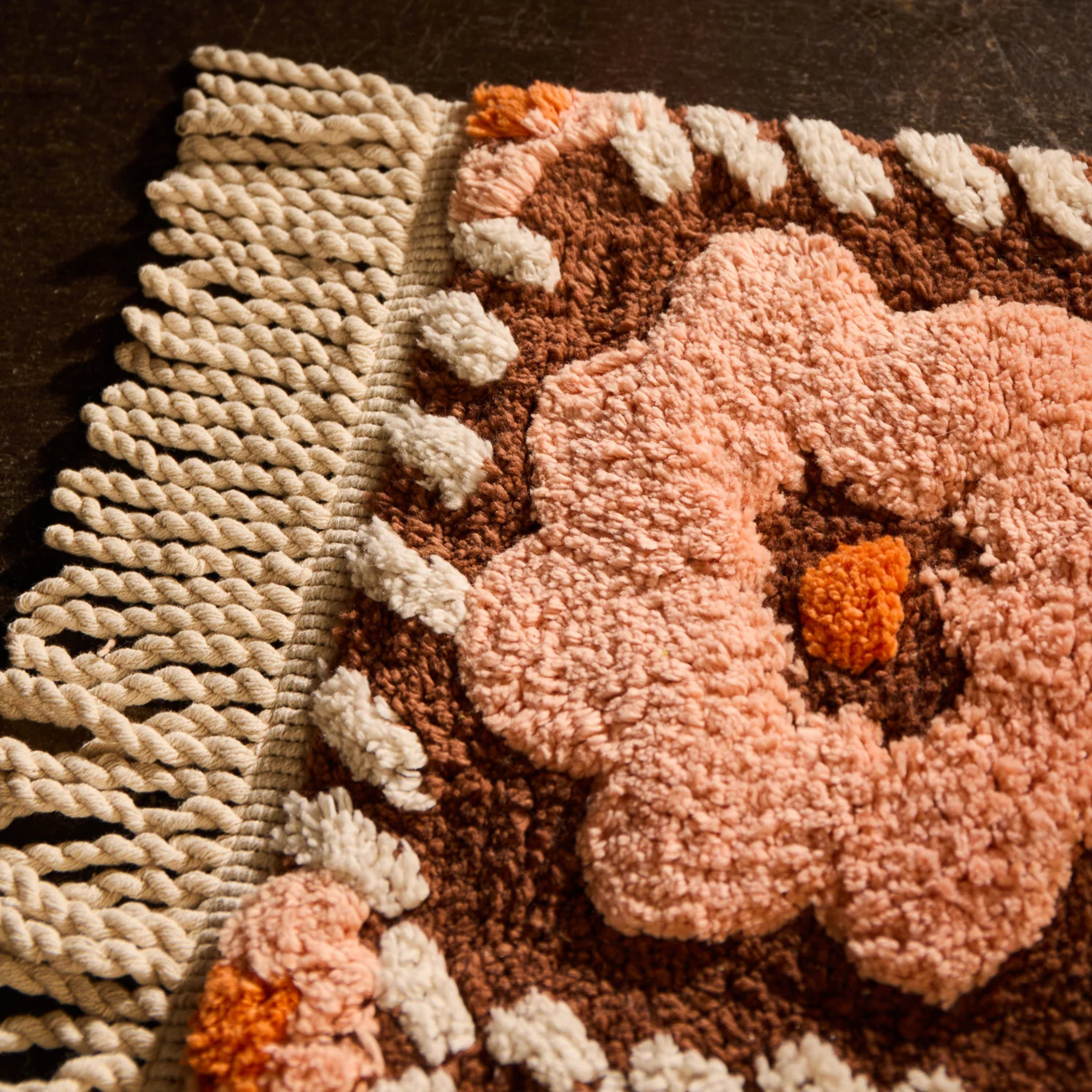a pink and brown floral bath mat. 