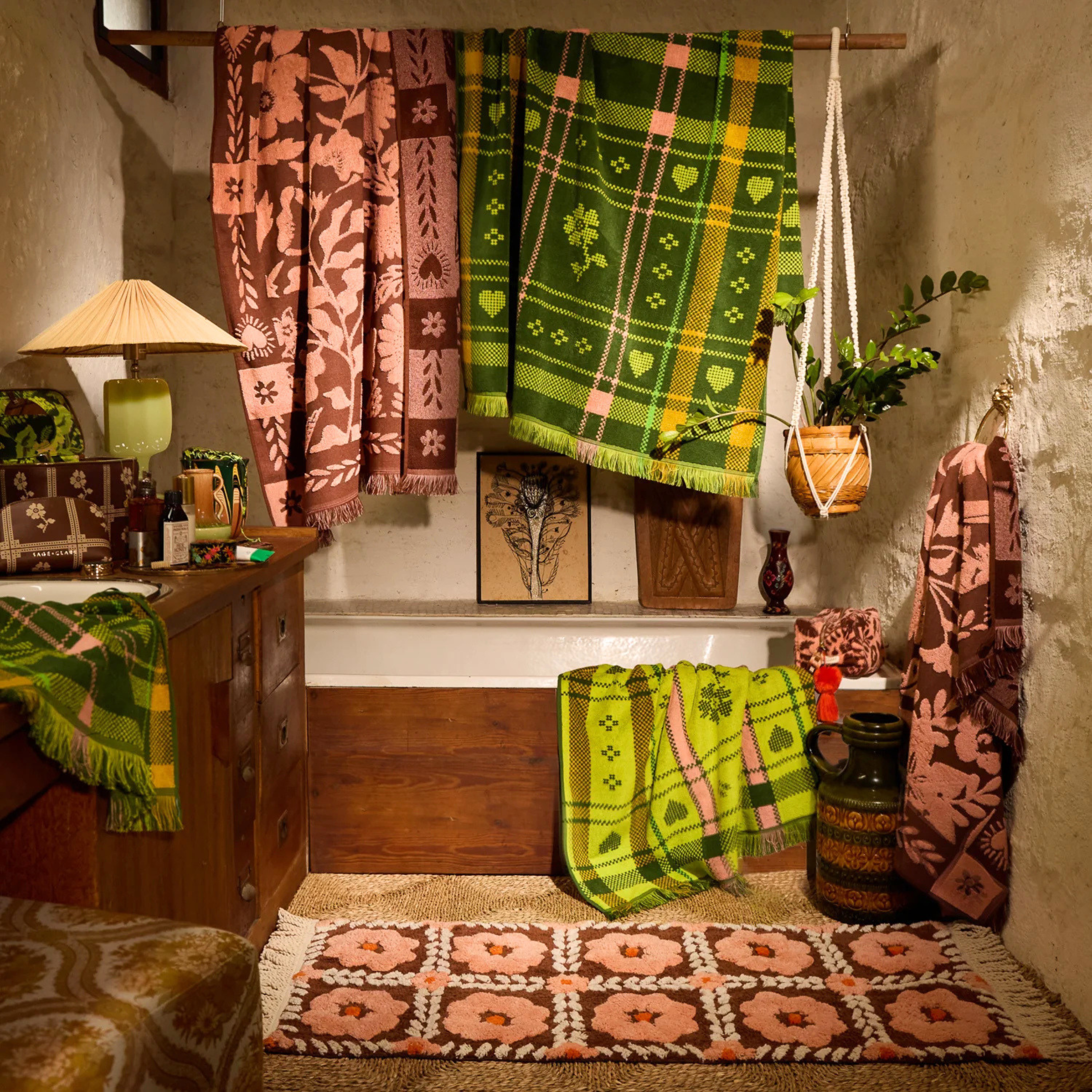 a floral bath mat with tassels on each end. 
