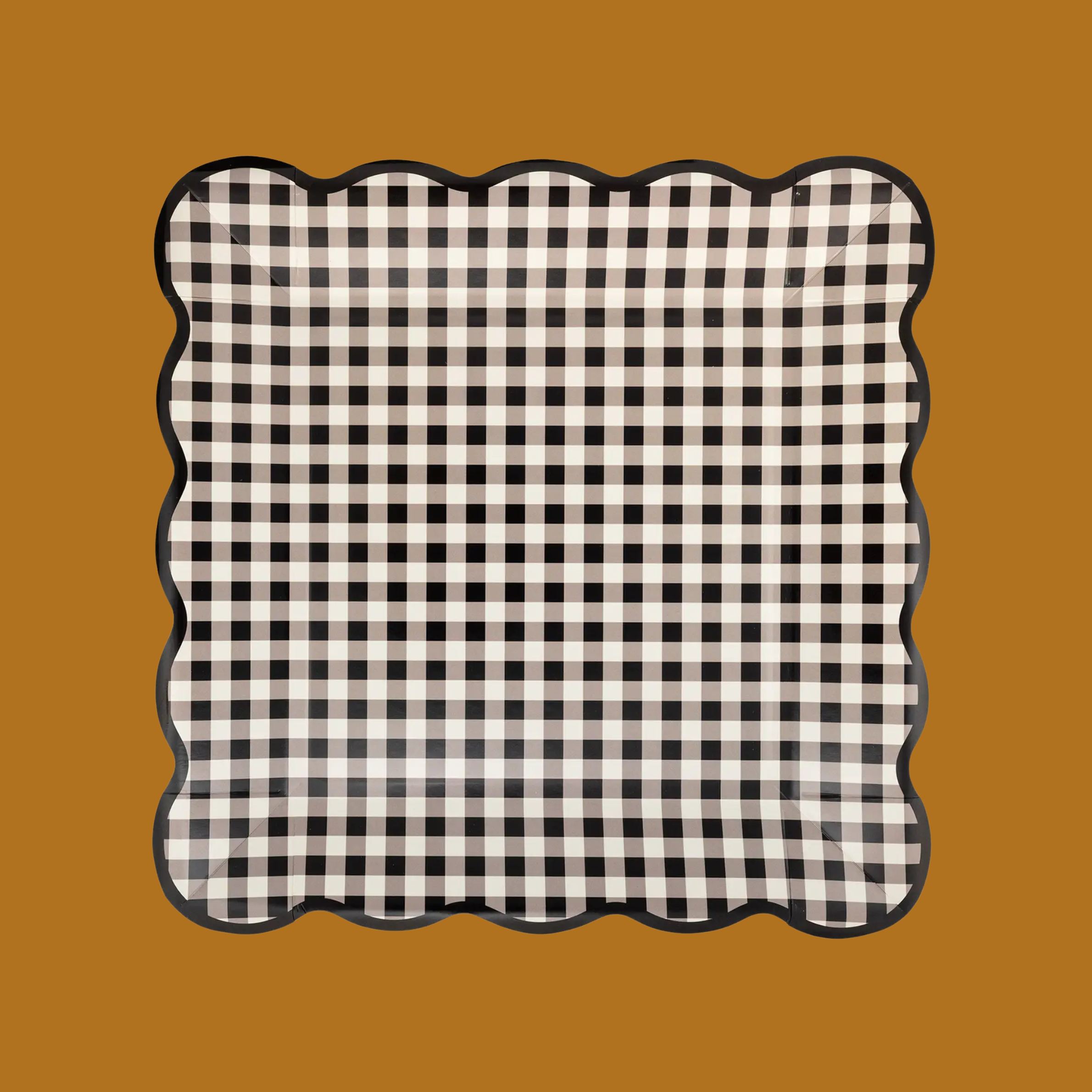 a black and white square paper plate with a scallop edge. 