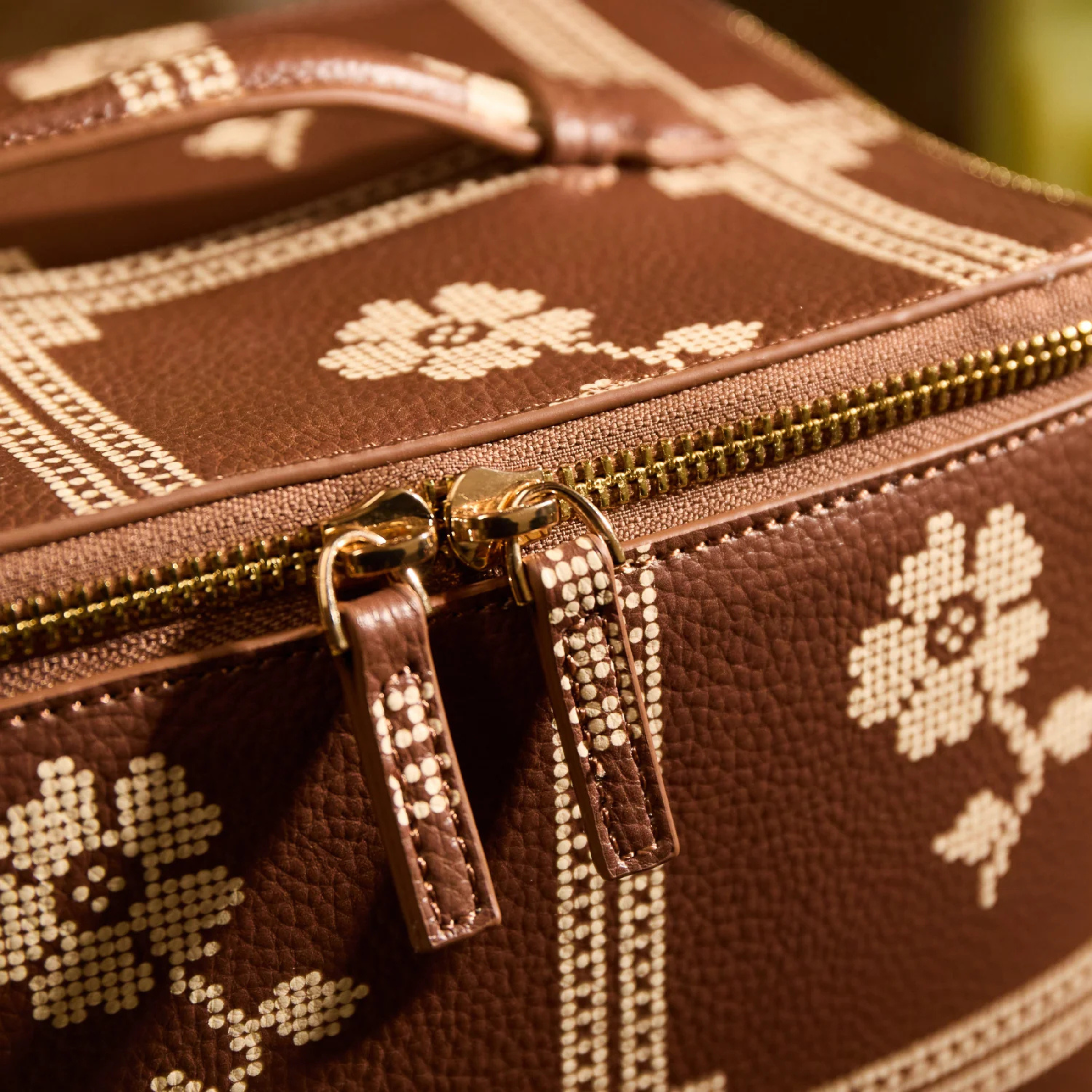 a brown and cream cosmetic case. 