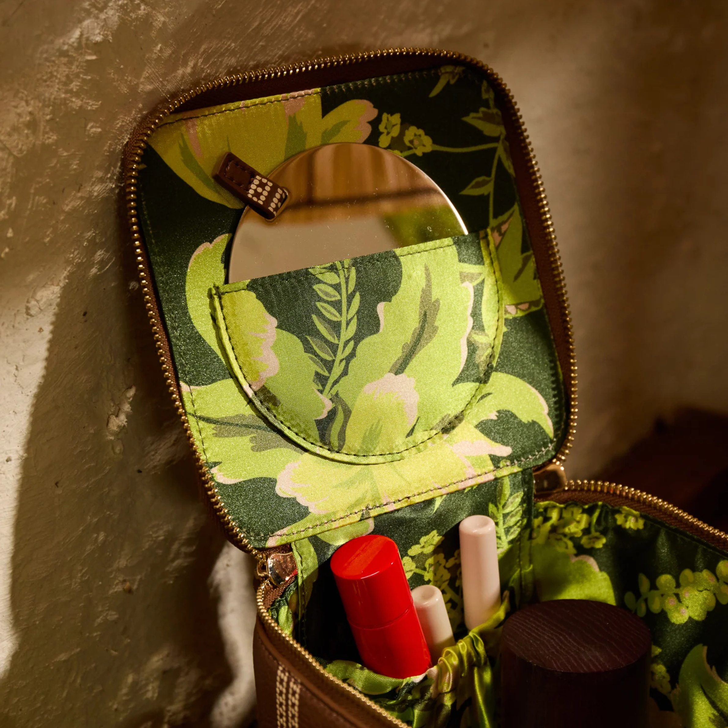 a brown and cream cosmetic case. 