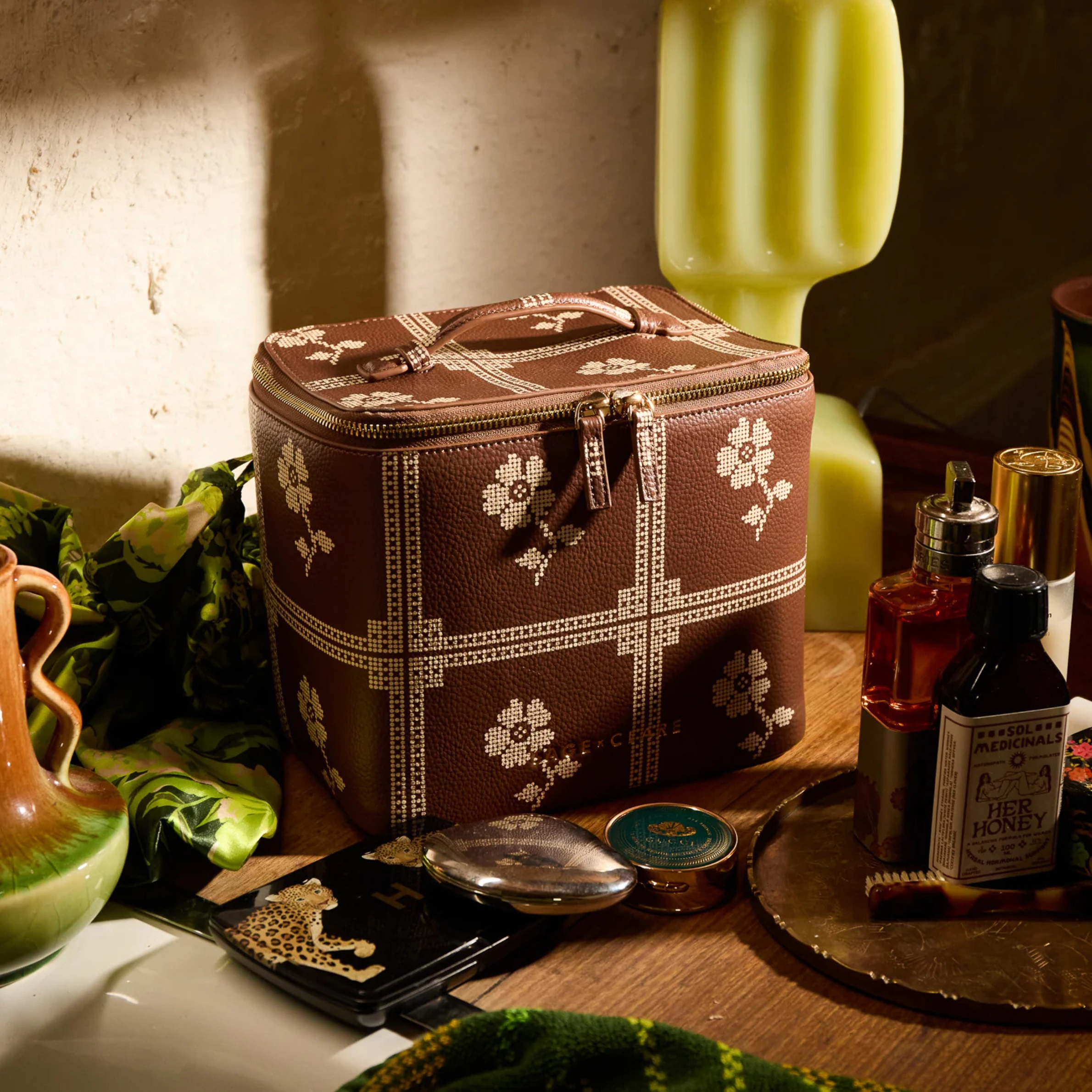 a brown and cream cosmetic case. 