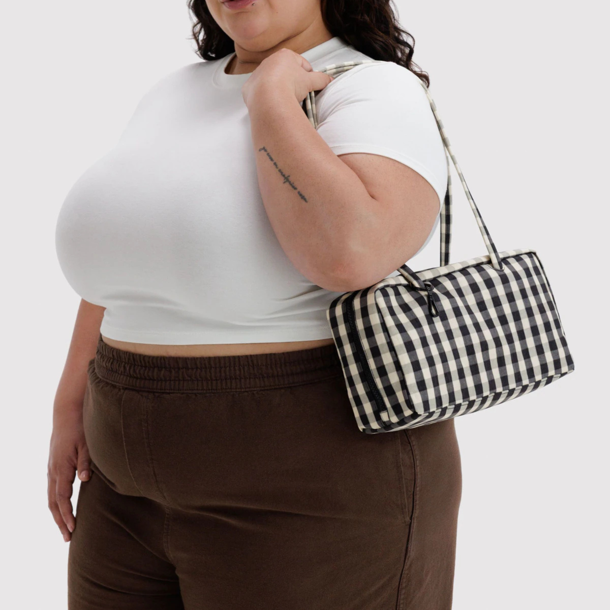 A cream and black gingham print shoulder bag.