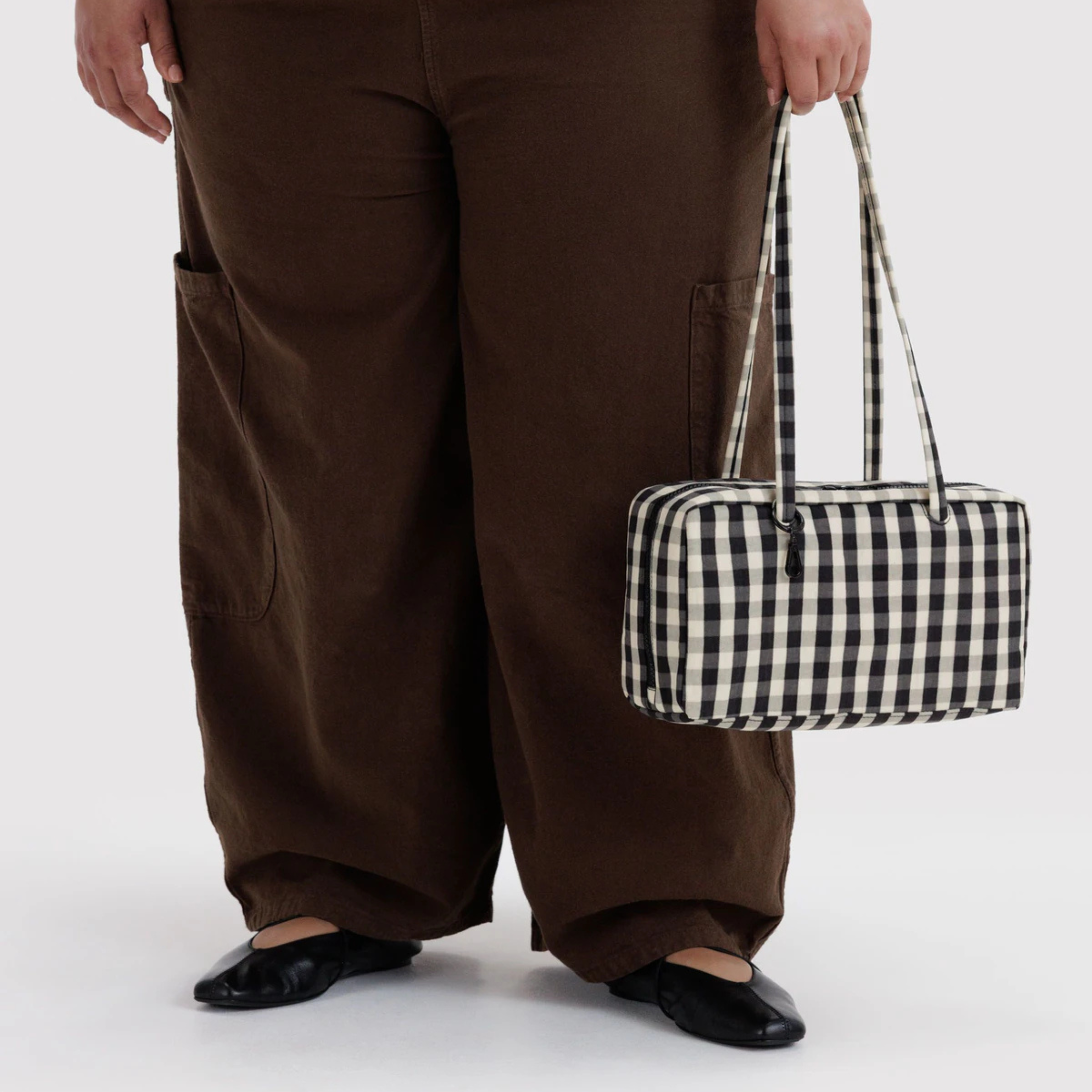 A cream and black gingham print shoulder bag.