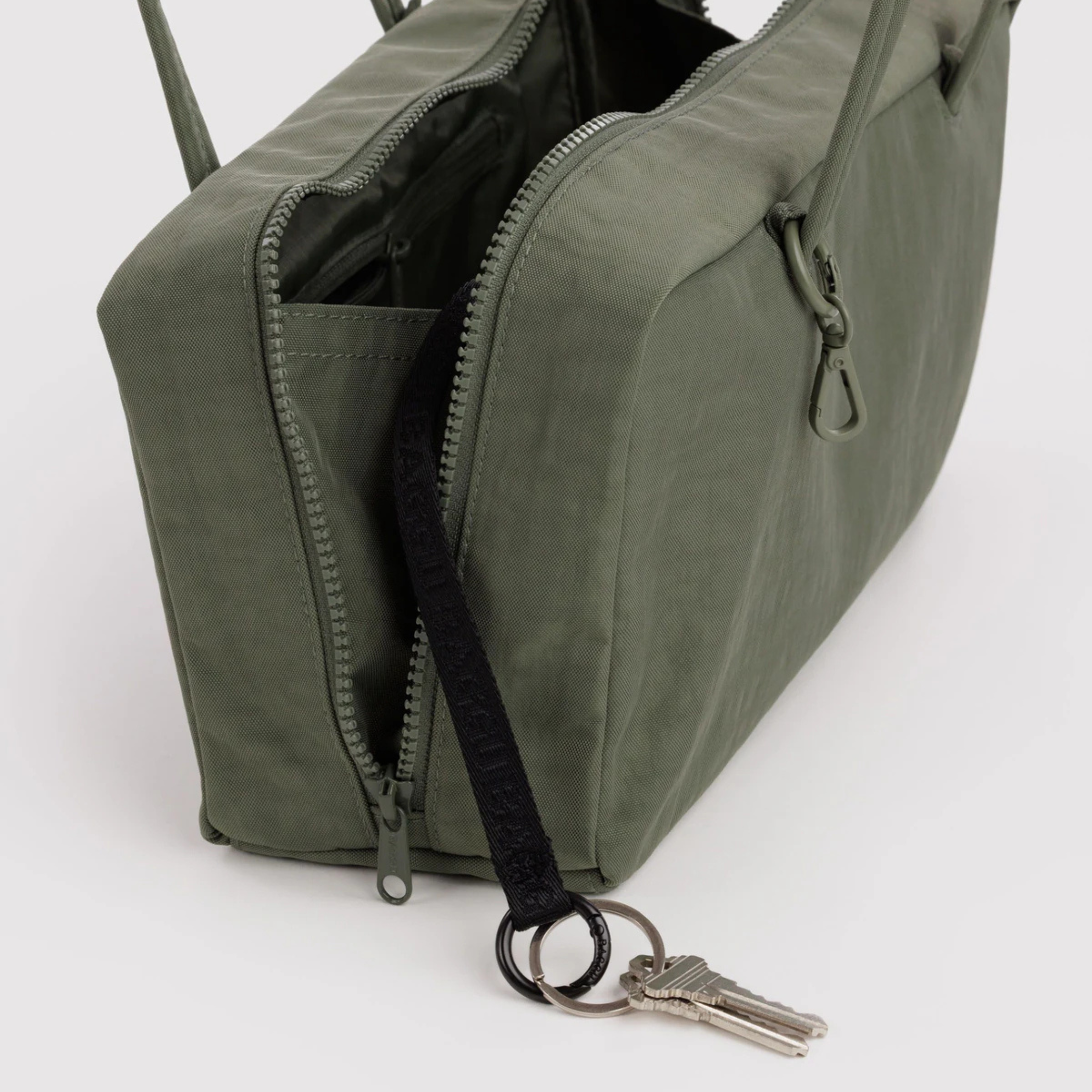 A green nylon shoulder bag.