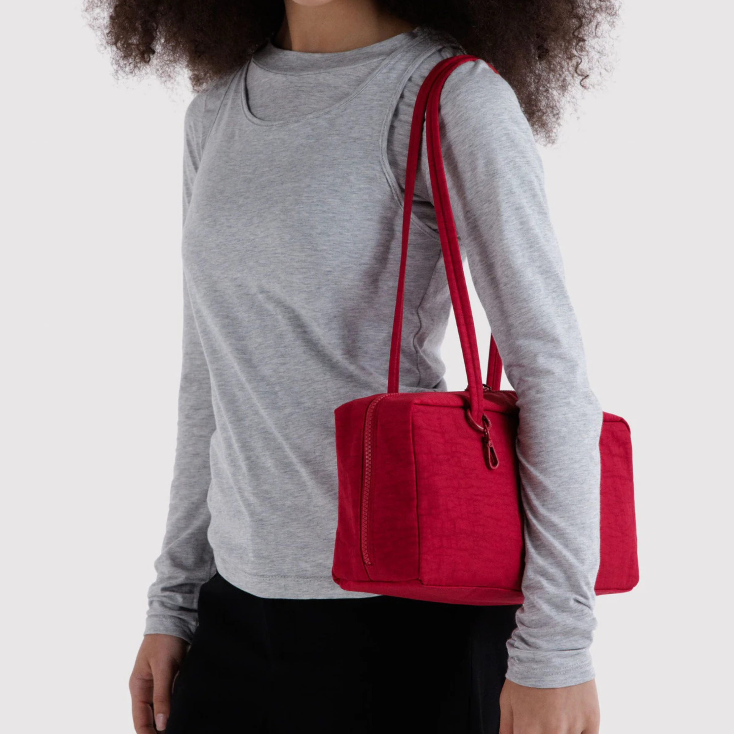 A red handbag with a shoulder strap.