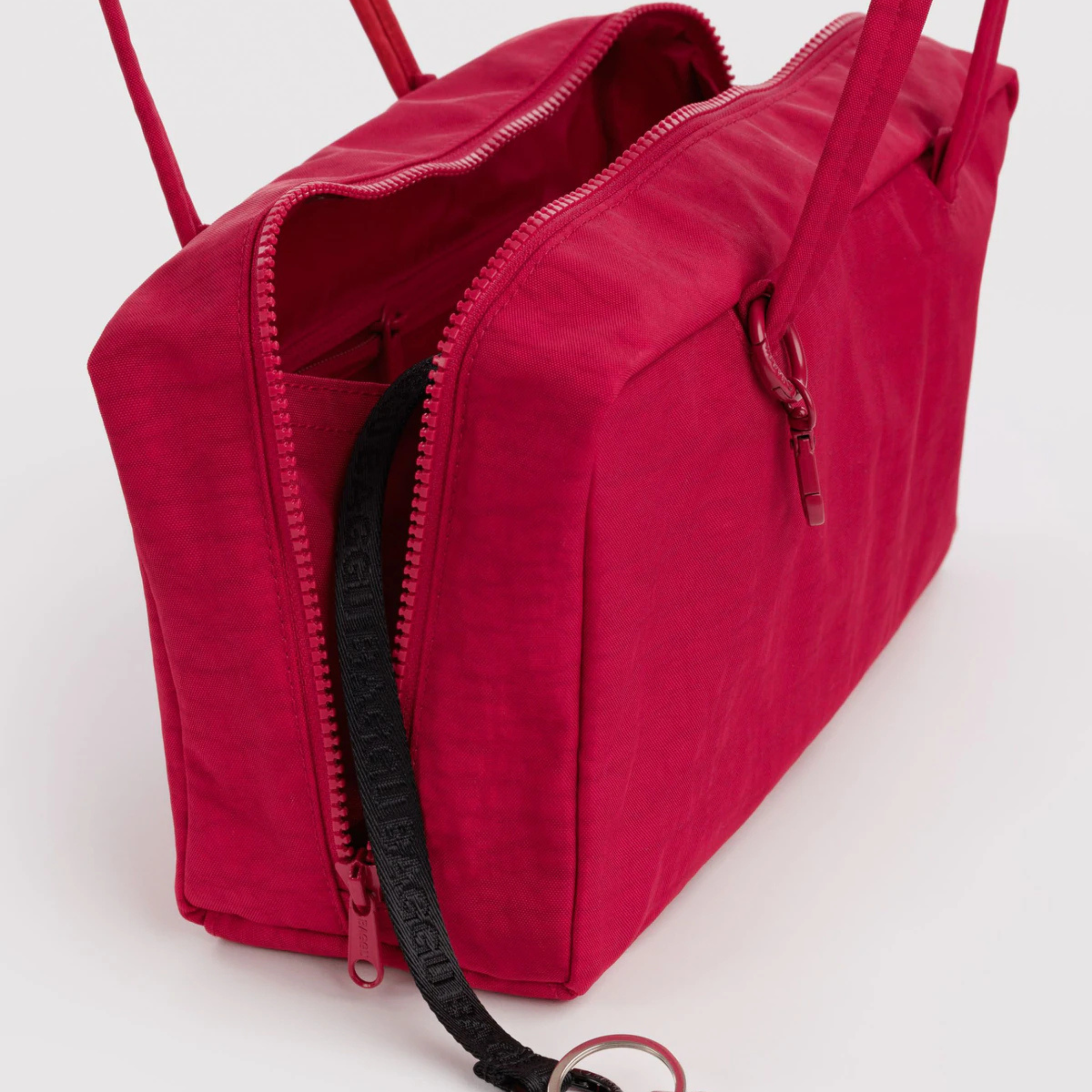A red handbag with a shoulder strap.