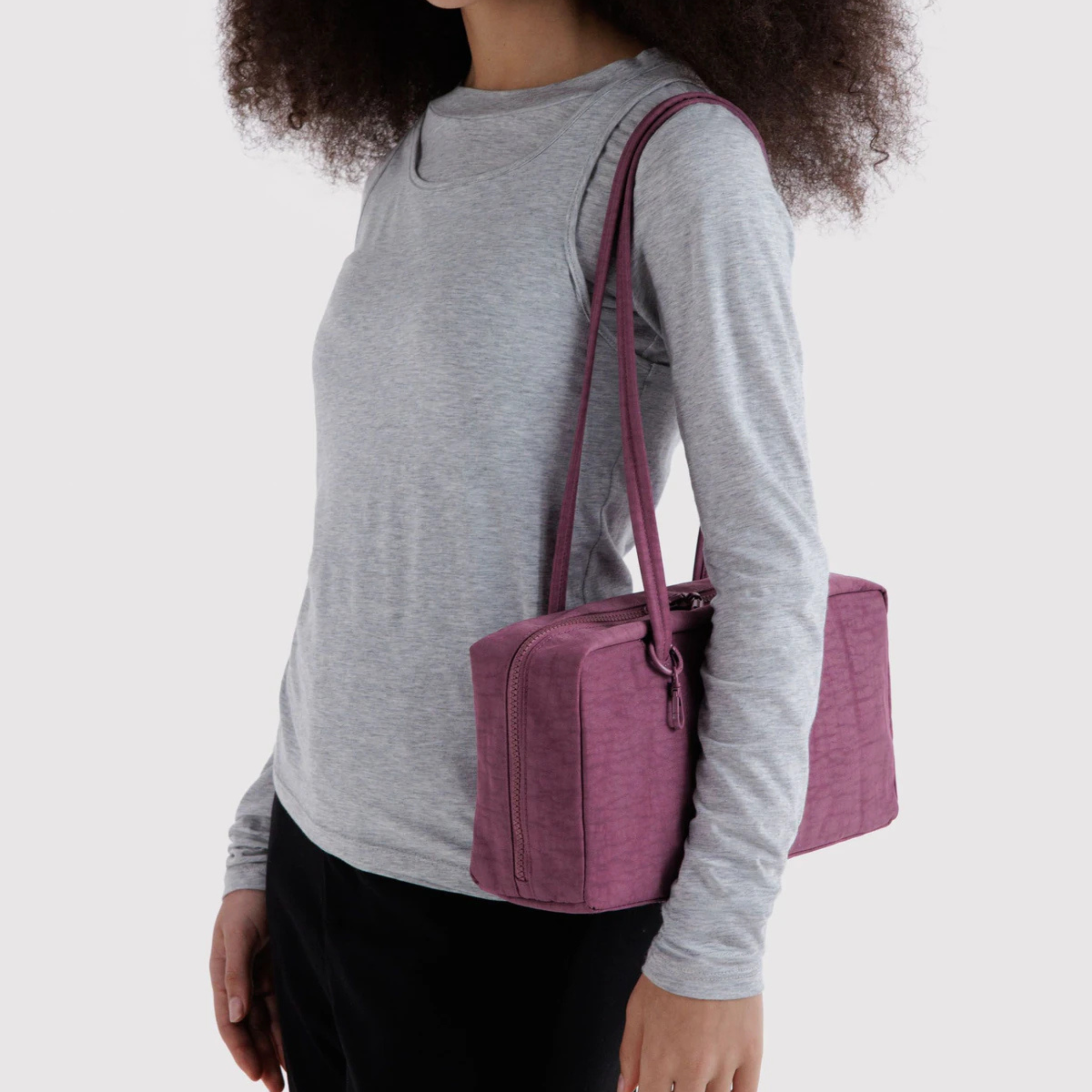 A purple rectangle shaped shoulder bag.