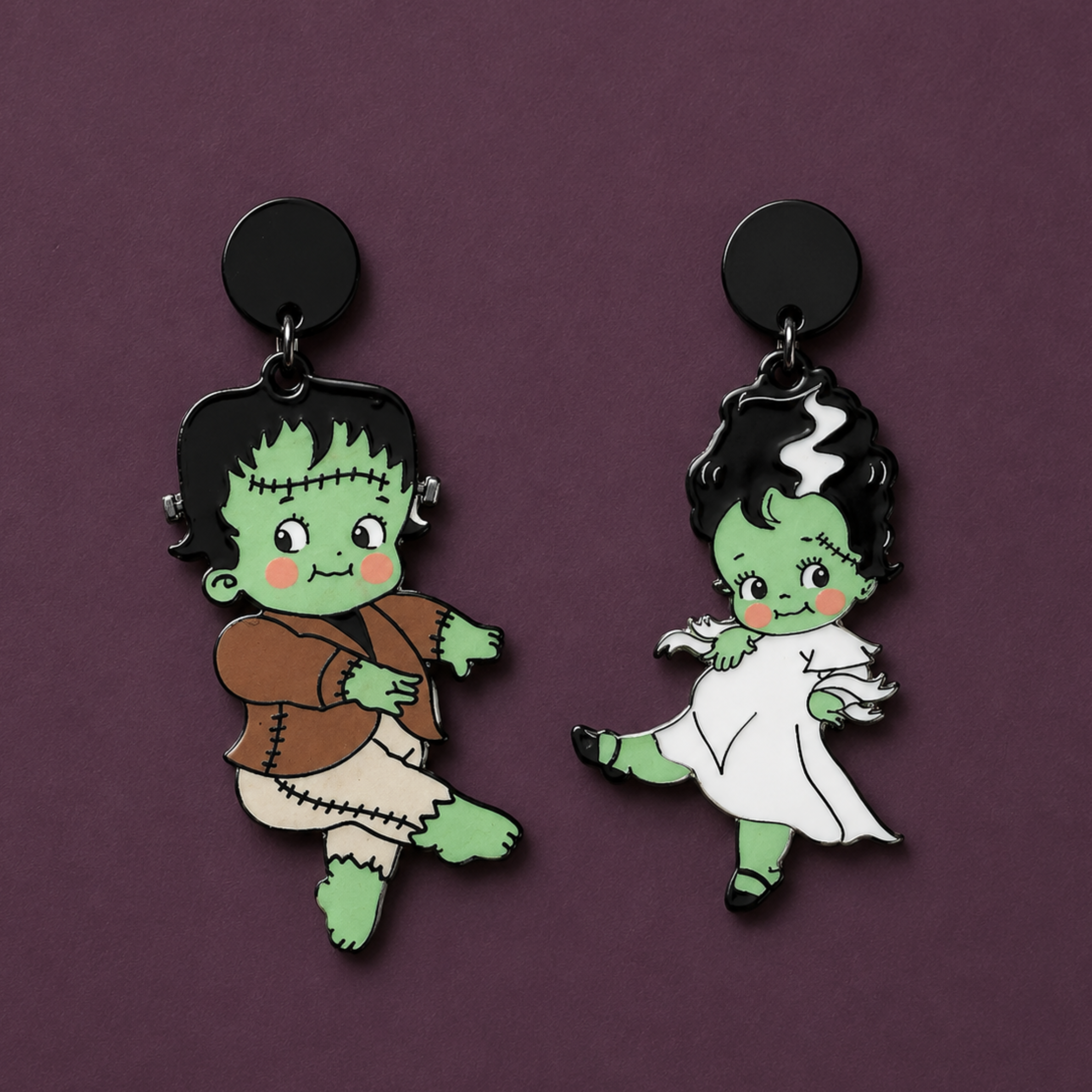 A frankenstein bride and groom shaped pair of earrings. 