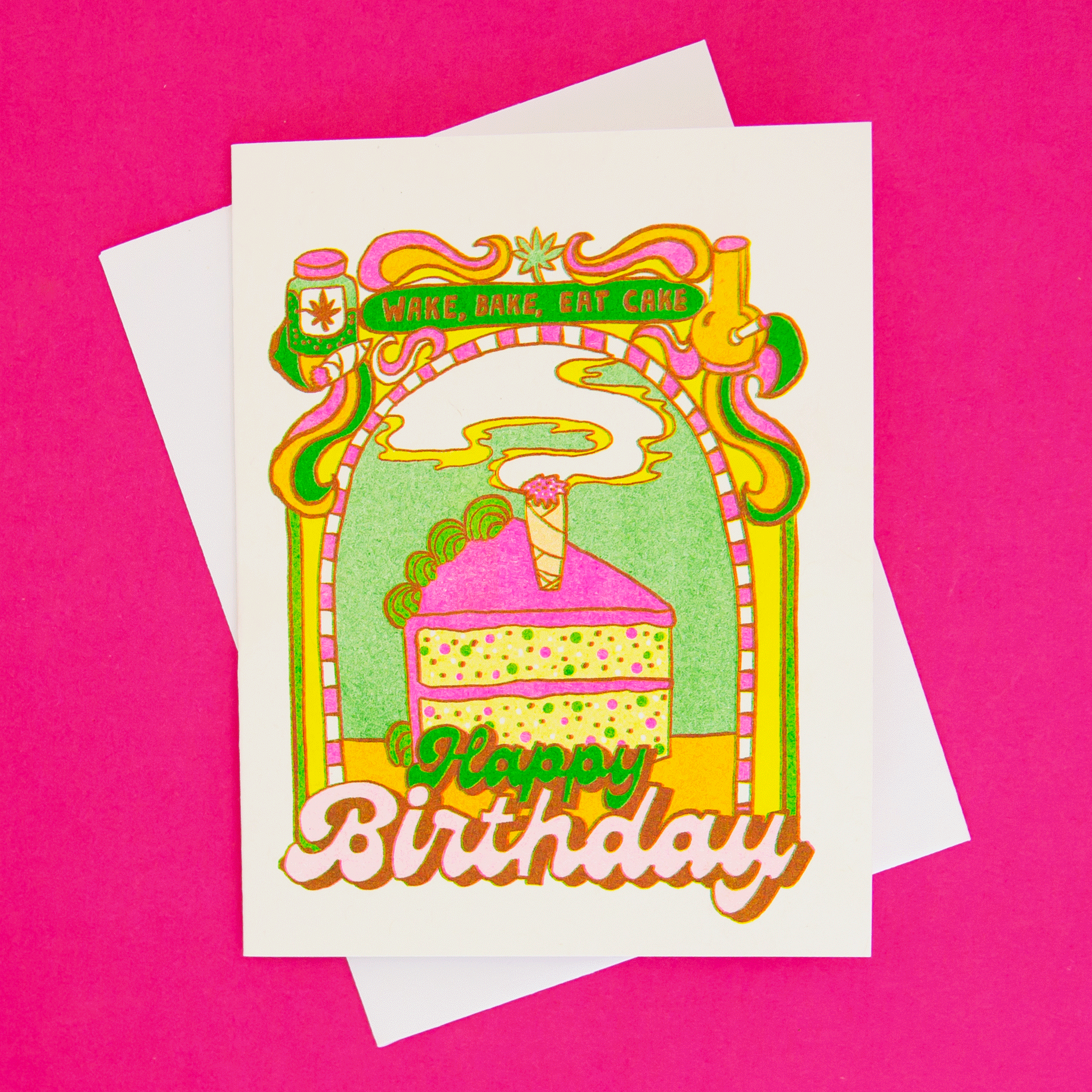 On a hot pink background is a colorful green, yellow and pink card with a cake illustration in the center with a pre-roll in the center and text that reads, &quot;Wake, Bake, Eat Cake Happy Birthday&quot;.