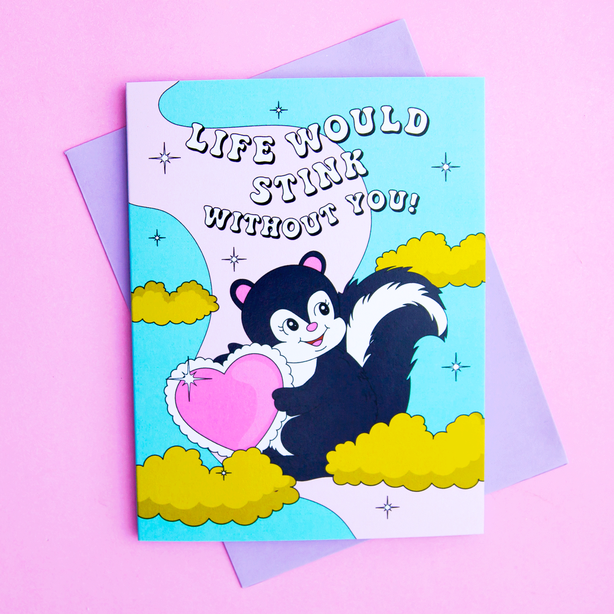 On a pink background is a card with a graphic of a skunk up in a colorful sky with clouds holding onto a pink heart and white text above that reads, "Life Would Stink Without You". 