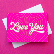 On a pink background is a hot pink card with gold heart shaped lines with ivory text in the center that reads, "Love You".