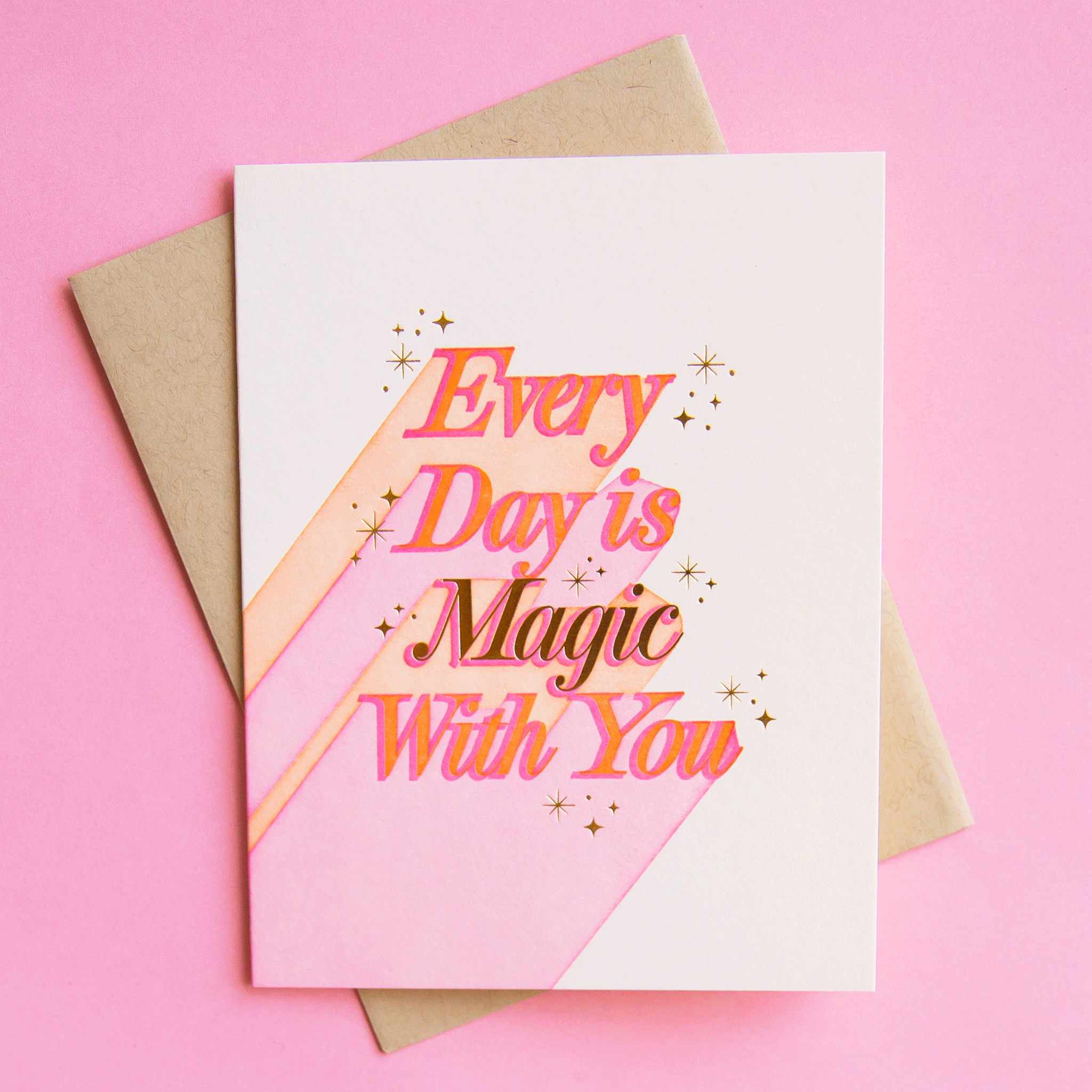 On a pink background is a white card with pink text that reads, "Every Day is Magic With You".