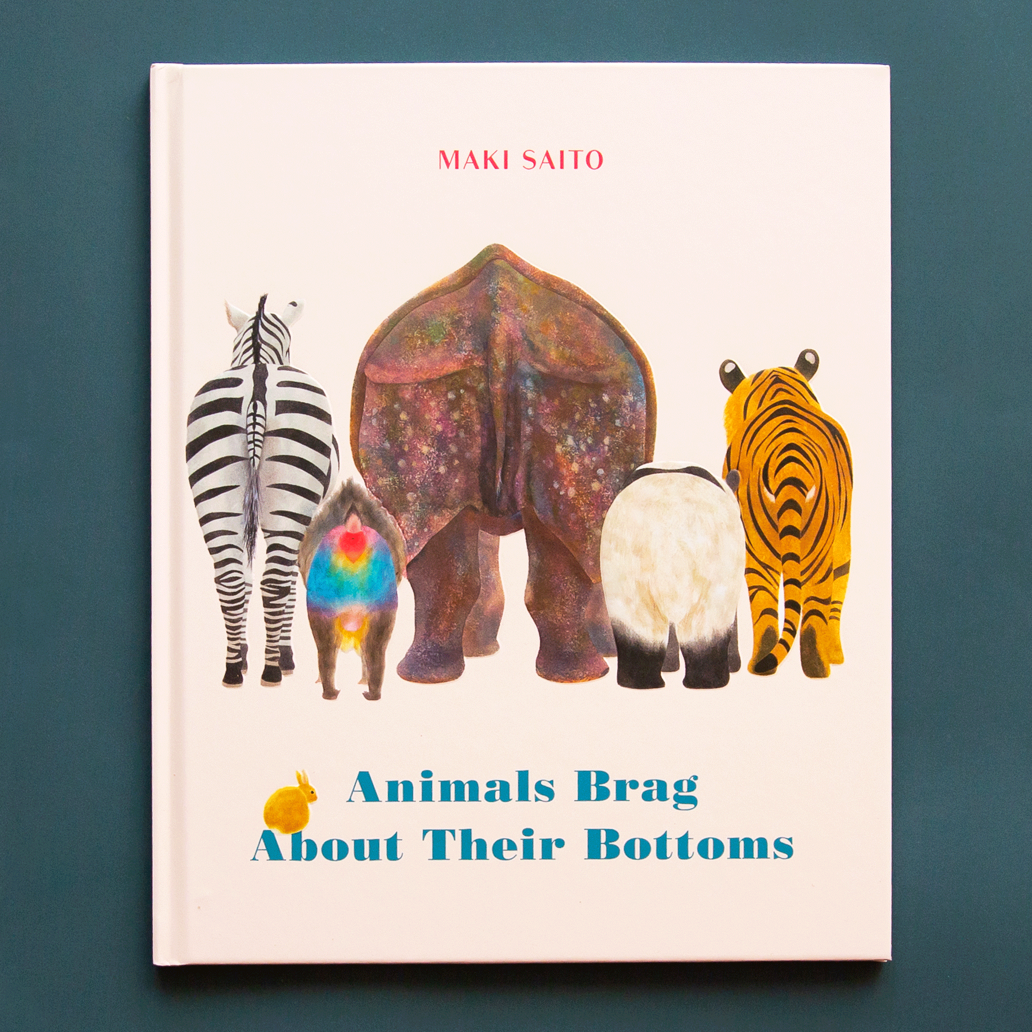 On a blue background is a white book with five different animals facing away with a title at the bottom that reads, &quot;Animals Brag About Their Bottoms&quot;. 