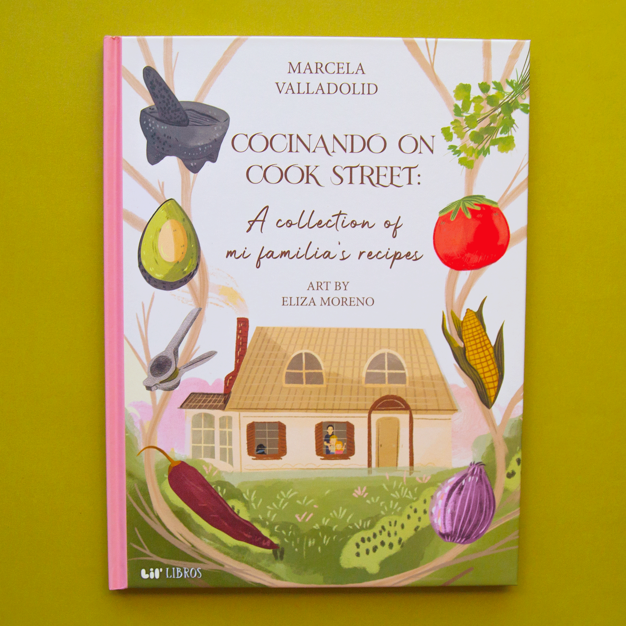 On a green background is a book cover with an illustration of a home with a family in the window and vegetables around the edges and text at the top that reads, "Cocinando On Cook Street A collection of mi familia's recipes". 