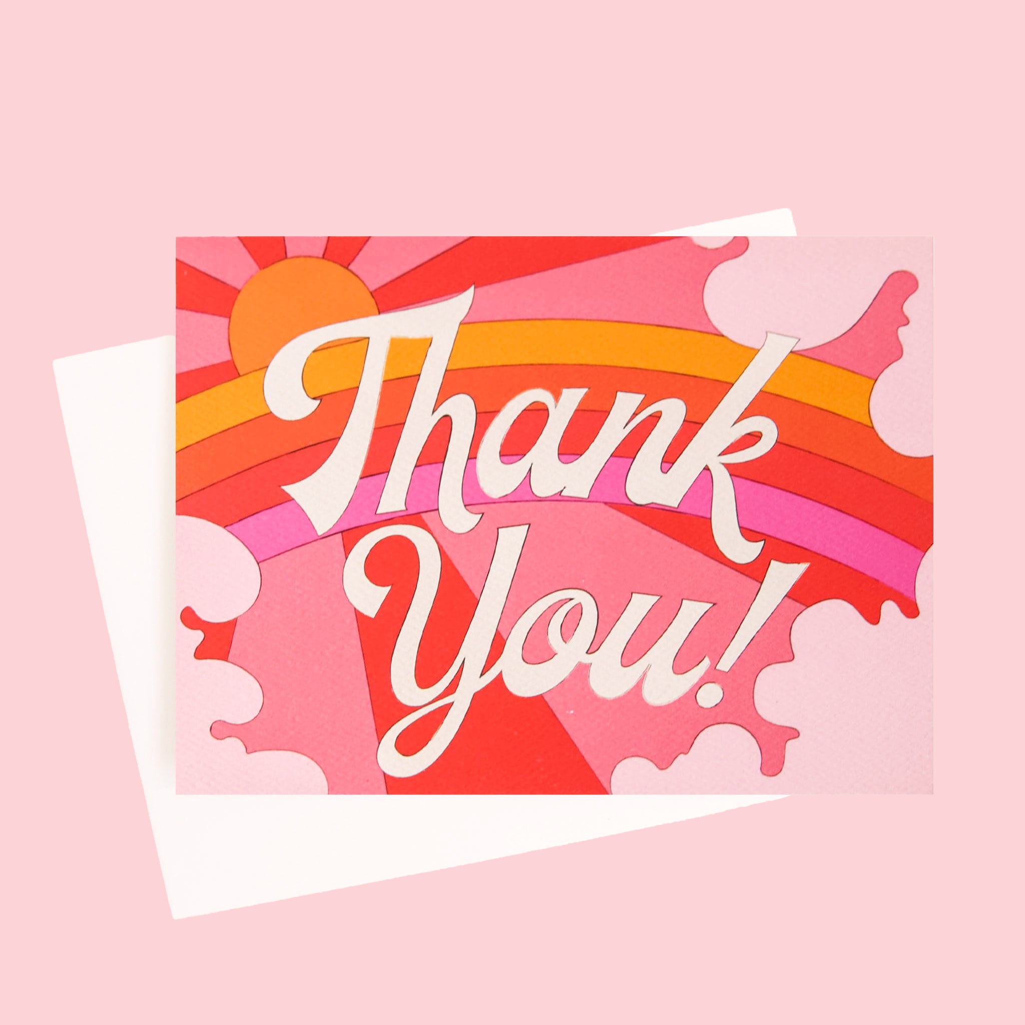 Card with a vibrant scene of a rosie toned rainbow and beaming pink and red sun. Soft pink cloud take up the edges. The center of the card reads 'Thank you!' in white cursive lettering.