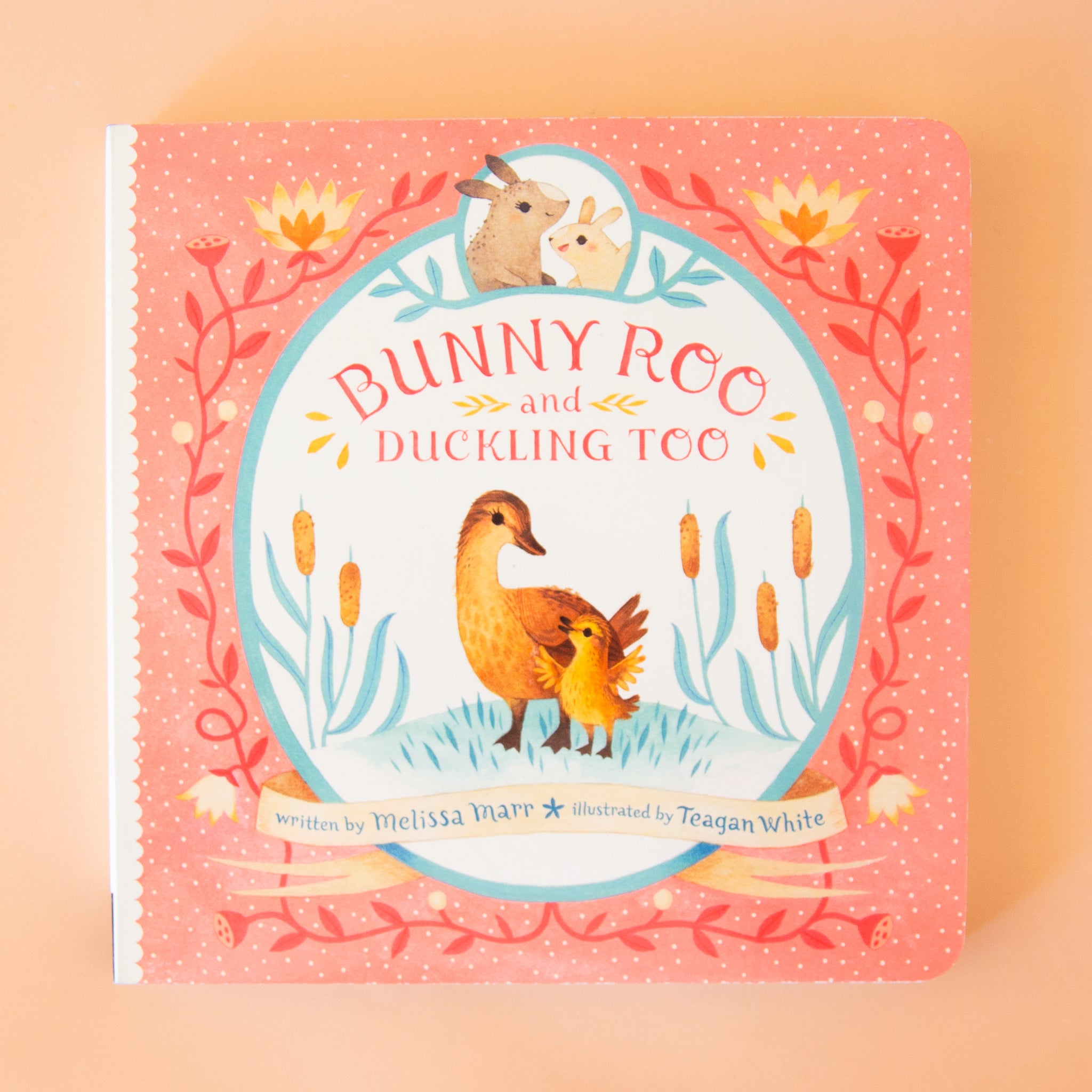On a tan background is a pink book cover with an illustration of ducks and bunnies and the title that reads, "Bunny Roo and Duckling Too". 