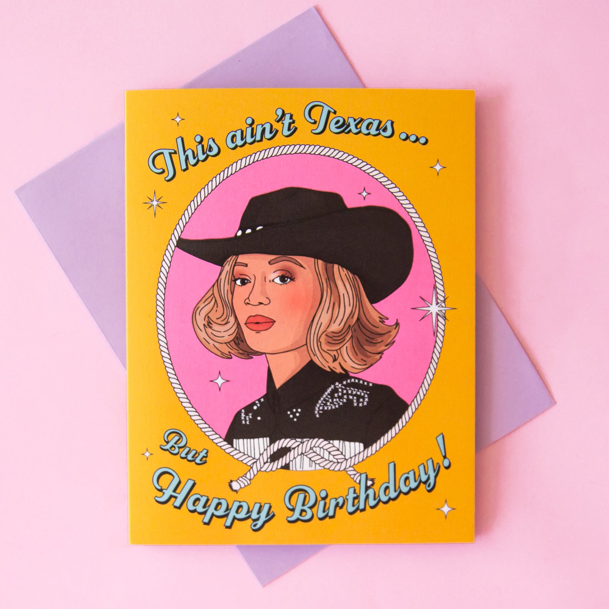On a pink background is a yellow card with a rope circle around an illustration of Beyonce wearing a cowgirl hat and text above and below that reads, "This ain't Texas... But Happy Birthday". 