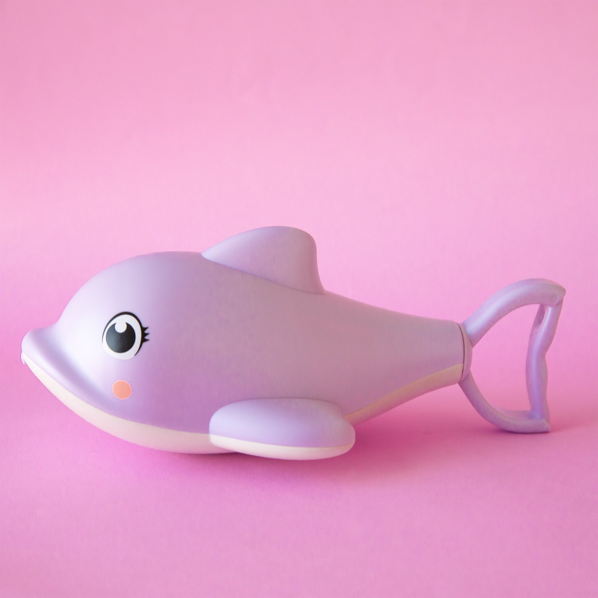 A light purple dolphin shaped pool or bath toy with a retractable handle at the end of the toy that resembles the dolphin&#39;s fin.