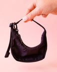 A mini black crescent bag shaped bag charm. 